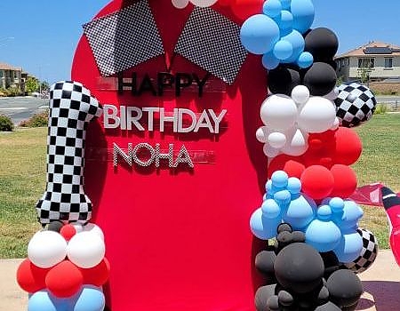 Red door decorated with balloons for party in Vallejo