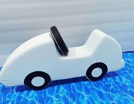 A white toy car in a pool for a themed event