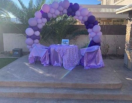 Purple and white balloon arch at a birthday party